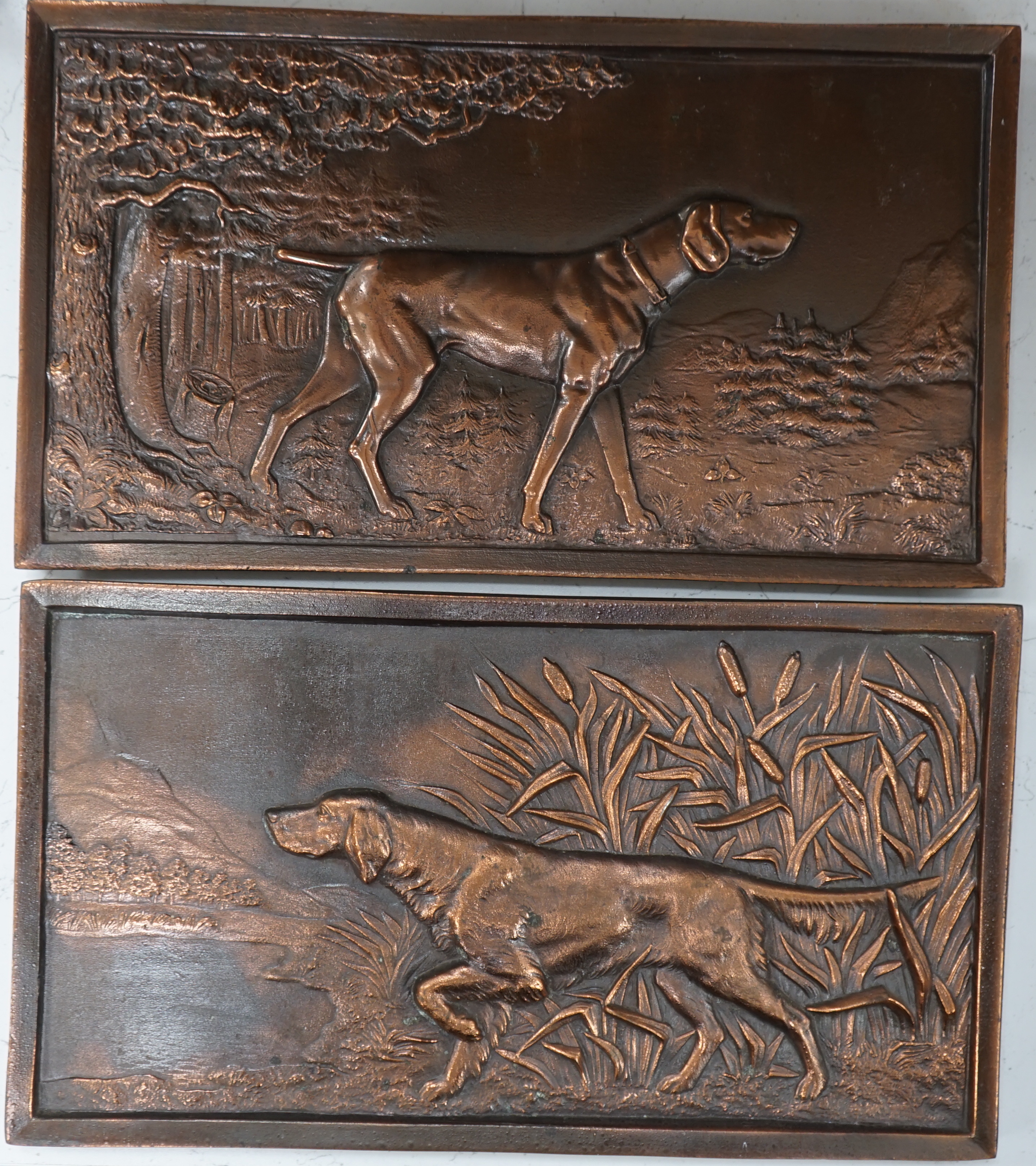 A pair of cast metal plaques of retrievers, 21 x 37cm